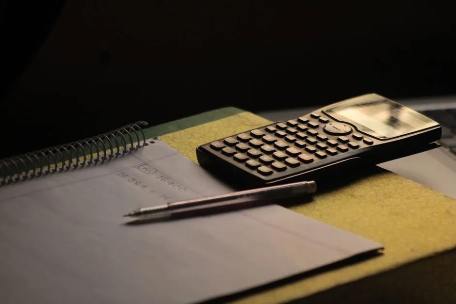 Calculator and notebook on a study desk